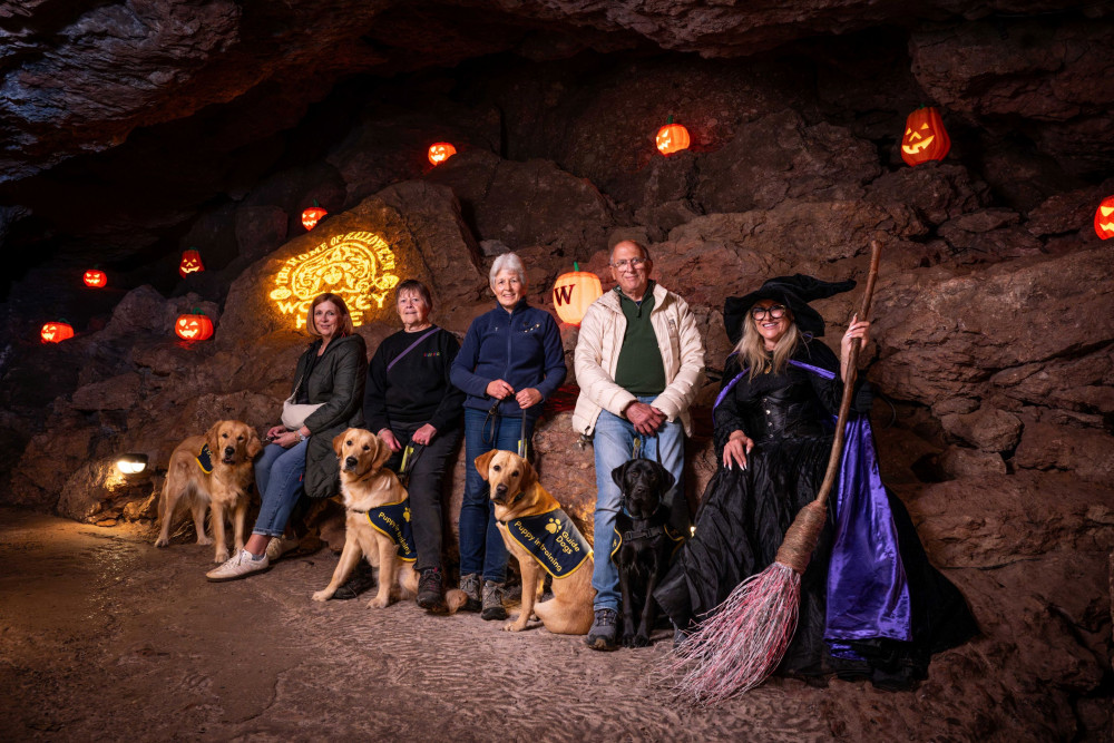 Puppy raisers with the Witch of Wookey Hole (Dave Pratt/Guide Dogs)