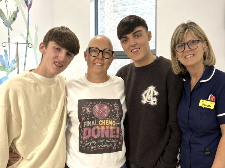 Dawn marks her final chemo session supported by son’s Lewis (left) Ethan and a member of the nursing team at Dorset County Hospital’s Fortuneswell Ward.