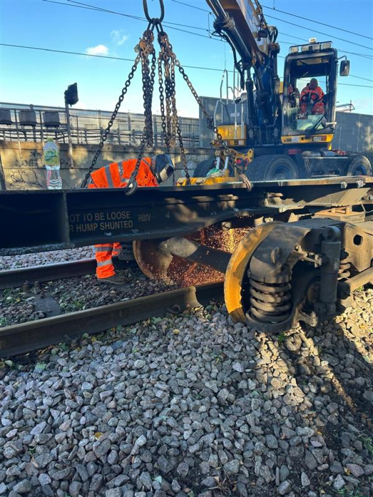 Work contuinues to clear the track and reopen the busy line at Barking. 
