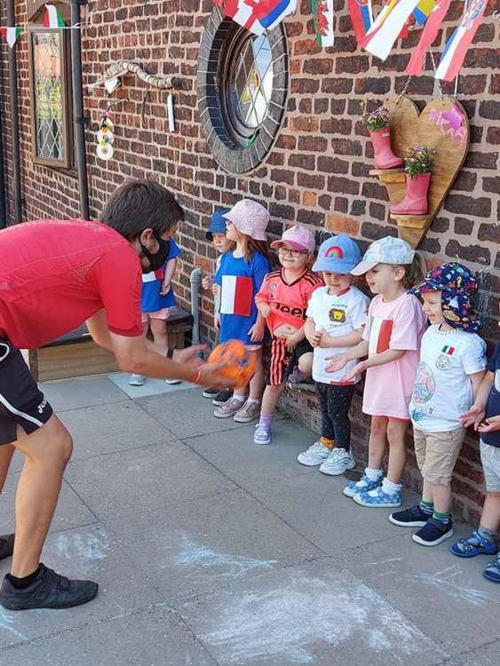Mr Ross and Preschool children competing in the catch the ball challenge Mr Ross and Preschool children competing in the catch the ball challenge