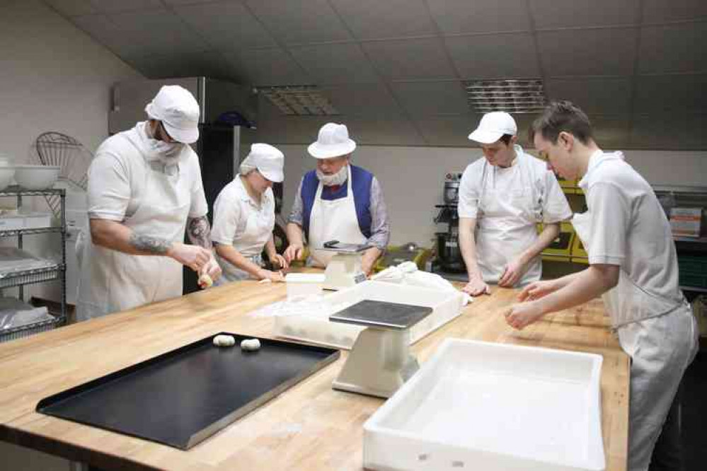 Henry Jefferies (craft trainer at Burns the Bread) training the Strode College baking apprentices