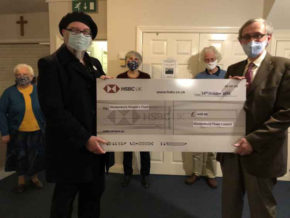 Cllr Jon Cousins hands £400 cheque to John Clare, chair of the Glastonbury People's Trust Cllr Jon Cousins hands £400 cheque to John Clare, chair of the Glastonbury People's Trust
