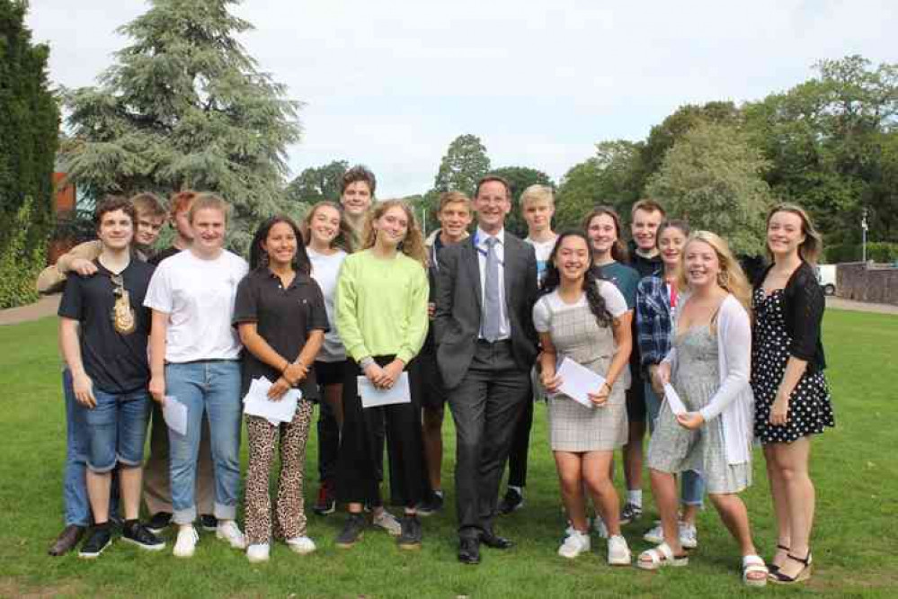 Pupils collecting their GCSE results with head master Alastair Tighe