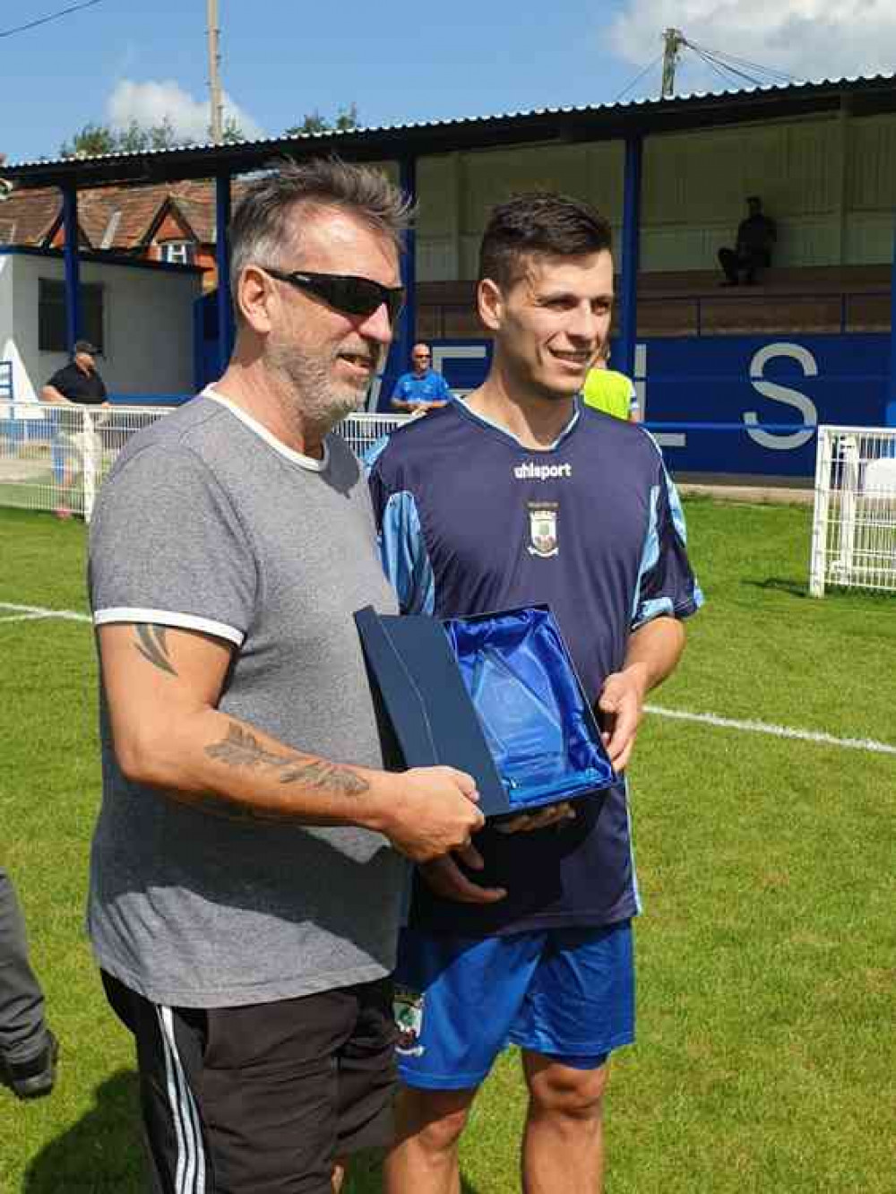 Mark Randall with his dad Paul who presented him with a gift from the club prior to his 600th game