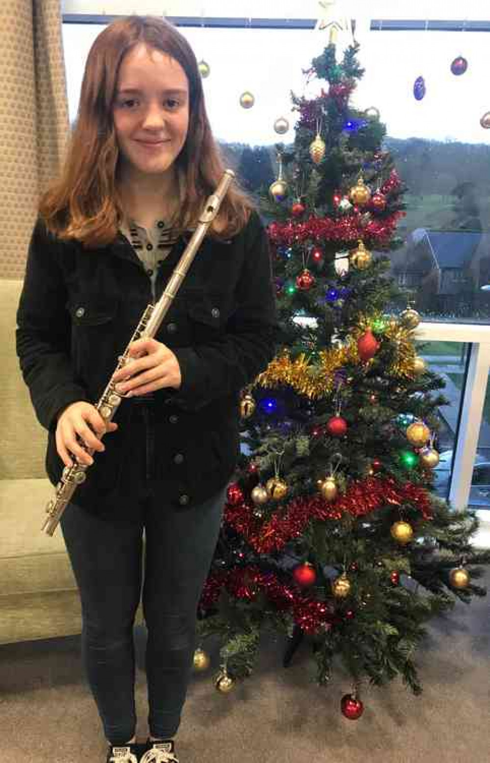 Blue School student Emma Bradley plays her flute for the residents