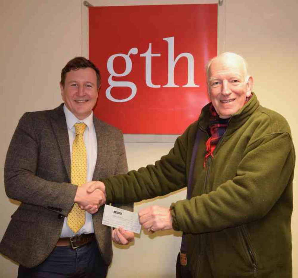 Sam Powell of Greenslade Taylor Hunt presents their £350 match-funding cheque to Ross Young of Wells SOUP