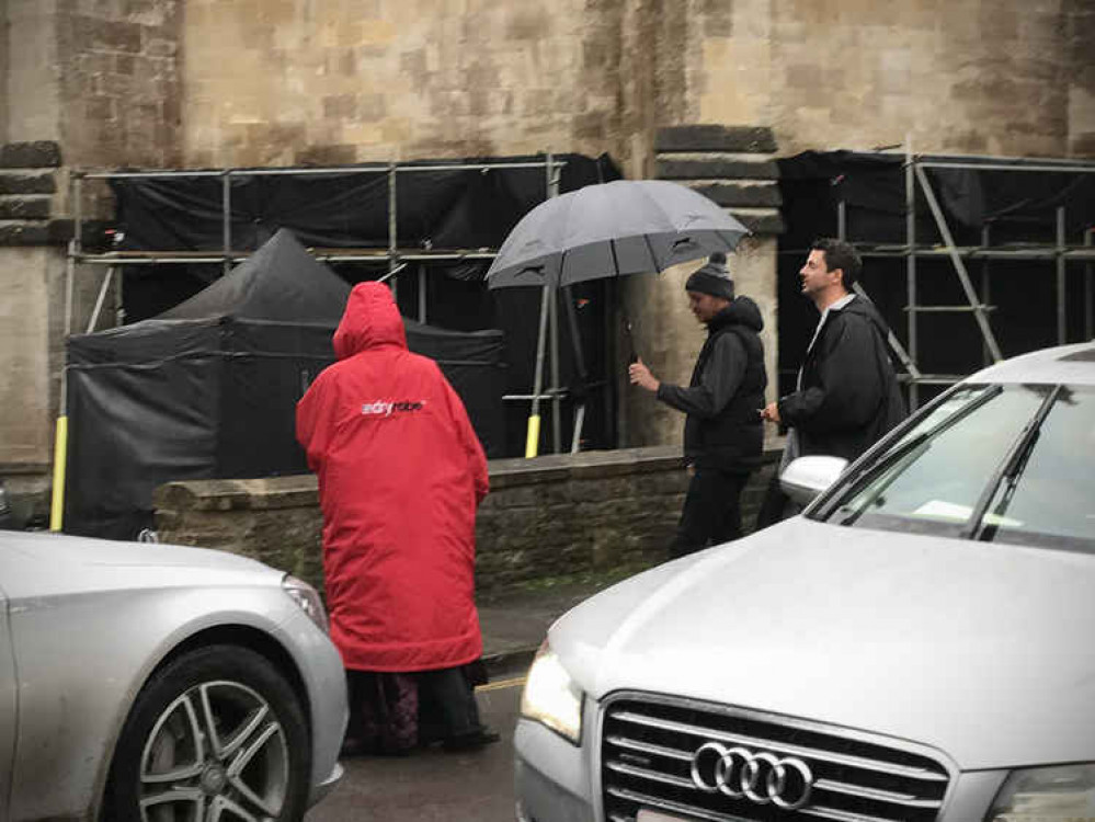 Teresa Palmer (in red rain jacket) with Matthew Goode filming A Discover of Witches in Wells