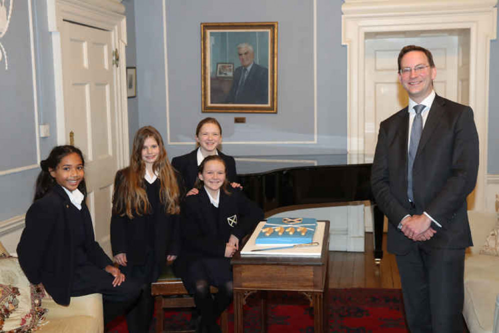 Head master Alastair Tighe with pupils and the celebratory cake