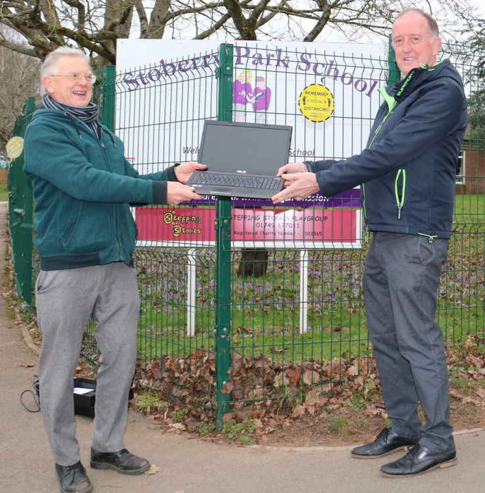 Ian Williams presents the second donated laptop to Stoberry School head Michael Hawkins