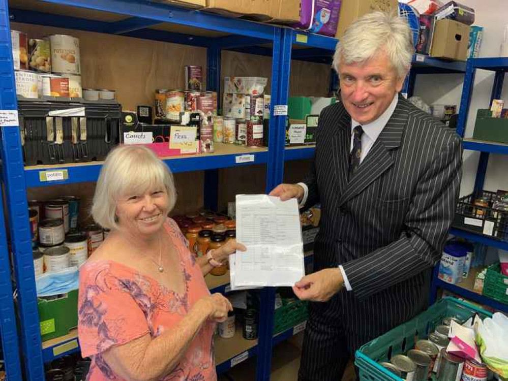 Sue Marland explains to the High Sheriff how they pack food parcels Sue Marland explains to the High Sheriff how they pack food parcels