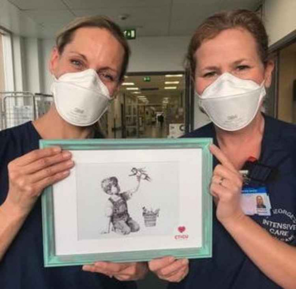 Sister Kim Tatham and Sister Myrna Scott with one of the prints